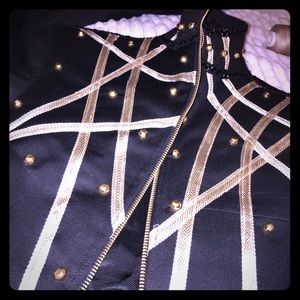 Unzipped black and god TeCo designed jacket.